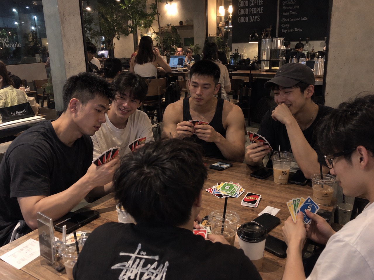 Friends playing a card game at a café